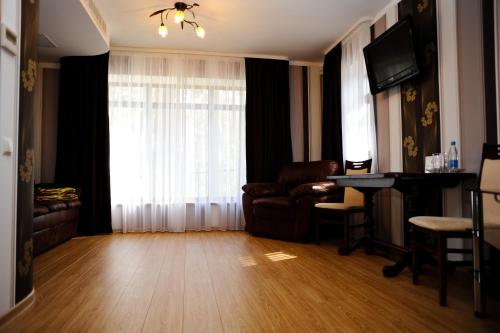 a living room with a couch and a table at Complex Mukhomor in Poltava