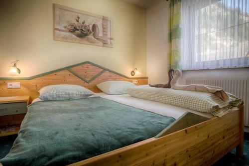 a bedroom with a large wooden bed in a room at Haus Egger in Neustift im Stubaital