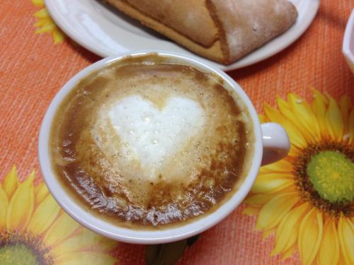 a cup of coffee with a heart in the middle at Hotel La Caravella in Bellaria-Igea Marina