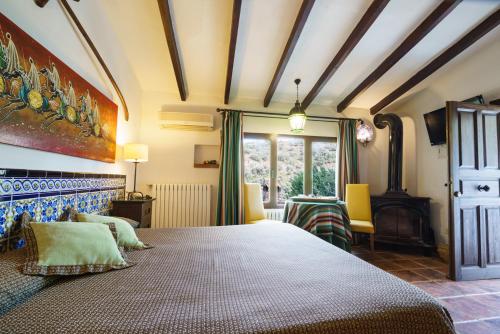 a bedroom with a large bed in a room at Hotel Rural Albamanjon in Ruidera