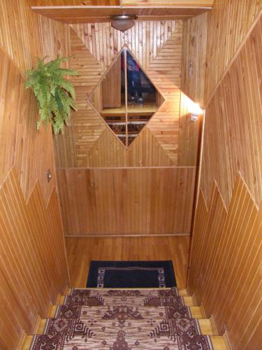 a wooden sauna with a window and a plant at Home for Guests Lakštingala in Šiauliai
