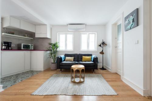 a living room with a couch and a table at Almamater Lisbon Apartments in Lisbon