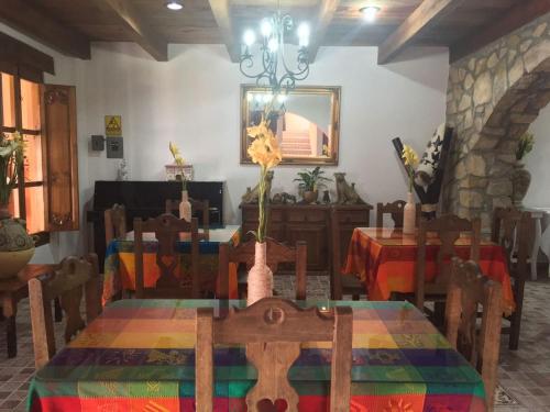 a dining room with a table with a colorful table cloth at Hotel Tierra Maya in San Cristóbal de Las Casas