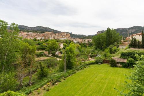 a view of a small village with a green lawn at Font del Pas in Beceite