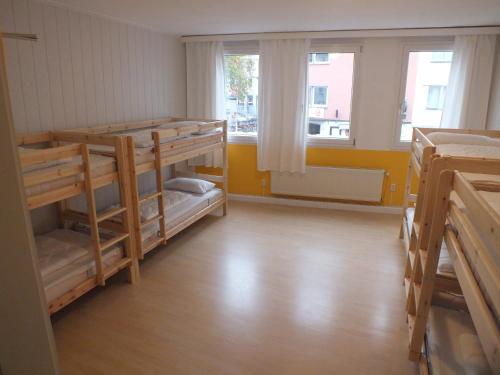 a room with two bunk beds and a window at Hostel 45 in Bonn