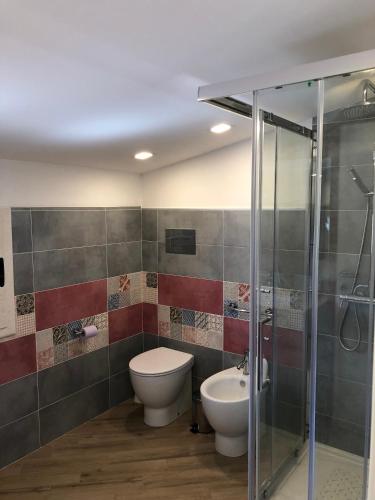 a bathroom with a toilet and a sink and a shower at Scopello Guidaloca Villas in Scopello