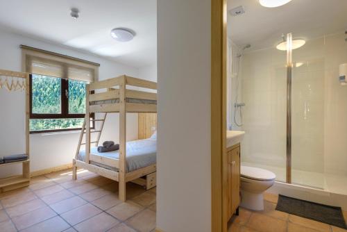 a bathroom with a bunk bed and a toilet at Camping Selva de Oza in Hecho