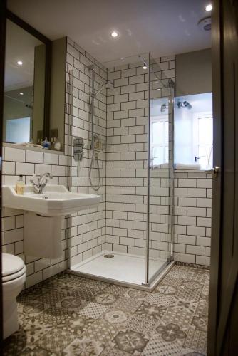 a bathroom with a shower and a sink and a toilet at The Lodges @ Barra Castle in Inverurie