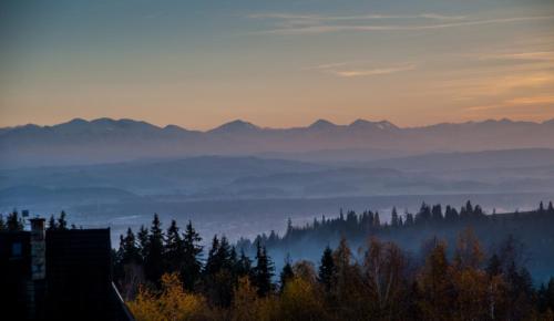a view of a foggy valley with mountains in the background at Apartamenty Blisko Słońca - Jacuzzi, Playgrounds in Nowy Targ