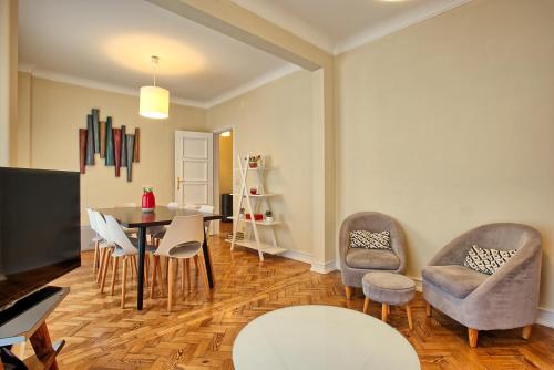 a living room with a table and chairs at Almirante Top Floor / Almirante Reis Avenue in Lisbon