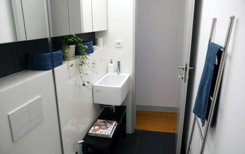 een kleine badkamer met een wastafel en een spiegel bij Santo Amaro's House in Lissabon