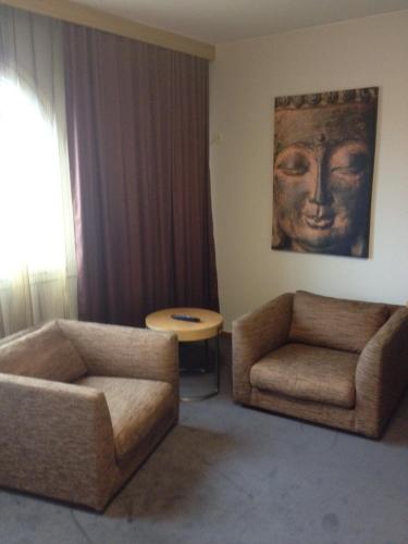 a living room with a couch and a table at Kumla Hotel in Kumla