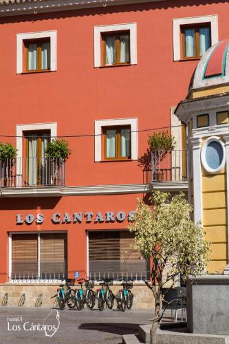a red building with bikes parked in front of it at Los Cantaros in El Puerto de Santa María