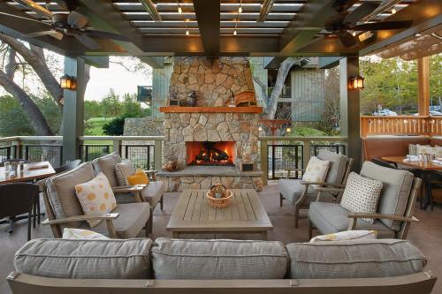 a patio with a fireplace and couches and a table at Temecula Creek Inn in Temecula