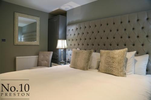 a hotel room with two beds and two lamps at No.10 Preston in Preston