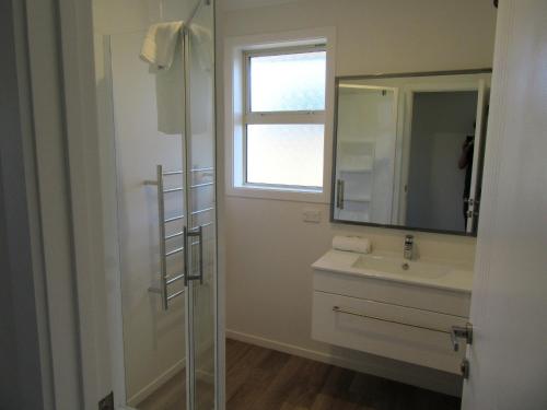 a bathroom with a sink and a mirror and a window at Tesoro in Lake Tekapo