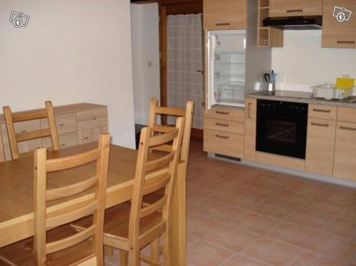 a kitchen with a wooden table and chairs at Rustico Aurora in Brontallo