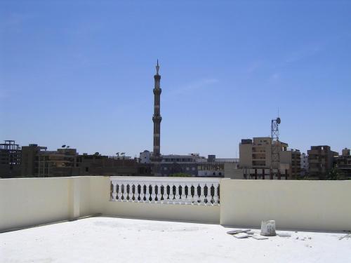 a white fence with a view of a city at Dream House Apartments Luxor in Luxor