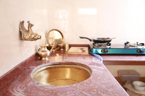 a sink in a kitchen with a counter top at Newa Home in Kathmandu