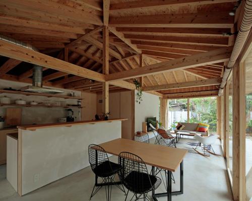 a kitchen and dining room with a table and chairs at SHINMINKA Villa GUSHIKEN in Motobu