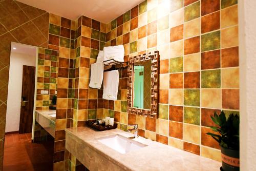 a bathroom with a sink and a mirror at T&T Story Hotel (Xi Gong Pier) in Kunming