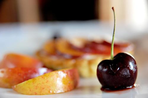 a cherry sitting on a table next to a piece of fruit at Villa Paradiso in Hartbeespoort