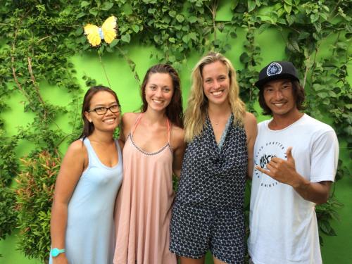 a group of people standing in front of a green wall at Blue Coco in Keramas