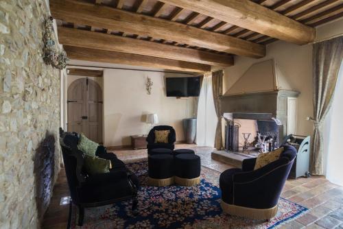 a living room with chairs and a fireplace at AGRITURISMO Ca' Maggio in Sassofeltrio