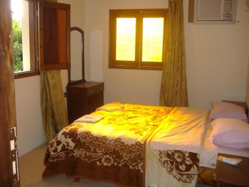 A bed or beds in a room at Dream House Apartments Luxor