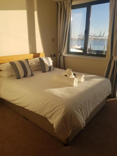 a bedroom with a large bed with towels on it at The Shipwreck Loft in Shotley Gate