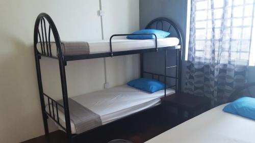 two bunk beds in a room with a window at GH Great Homes in Kuching