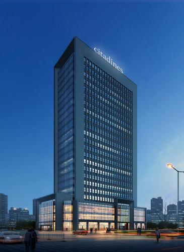 a tall building with a sign on top of it at Citadines Gaoxin Xi'an in Xi'an