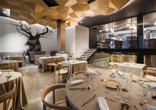a restaurant with tables and chairs and a deer head on the wall at One Shot Mercat in Valencia
