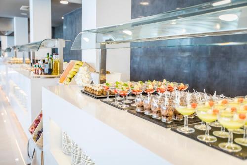 a buffet line with many glasses of drinks at Dos Playas - 30º hotels in Puerto de Mazarrón