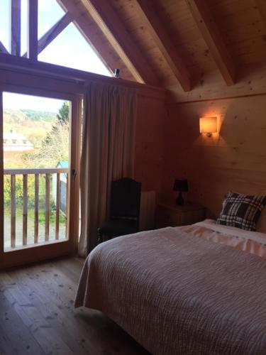 a bedroom with a bed and a large window at Pandy B&B in Dorstone
