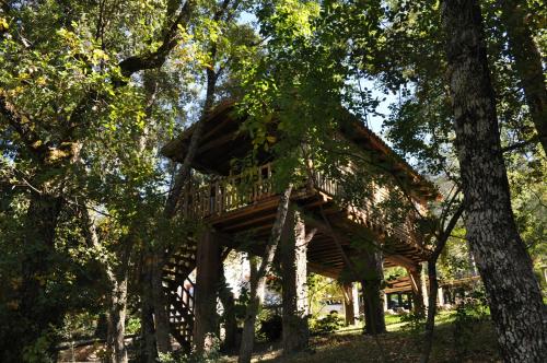 a tree house in the middle of some trees at Hotel Rural Convento Santa Maria de la Sierra in Arroyo Frio