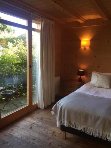 a bedroom with a bed and a large window at Pandy B&B in Dorstone