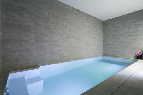 a swimming pool in a room with blue lighting at Veeve - Saint-Lambert Deluxe in Paris