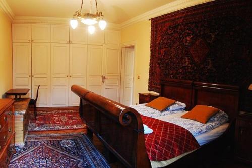 a bedroom with a wooden bed with orange pillows at Royal in Kraków