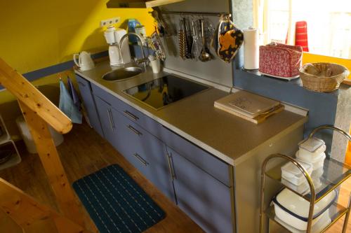 a small kitchen with a sink and a counter at Ferienwohung II (Schardeich) in Pellworm