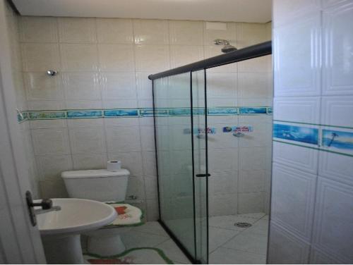 y baño con ducha, aseo y lavamanos. en Pousada Aguas do Rio Pardo en Cândido Sales