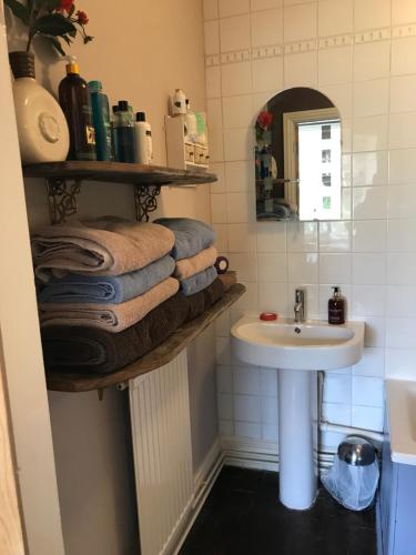 a bathroom with a sink and a mirror and towels at The Clytha Arms in Abergavenny