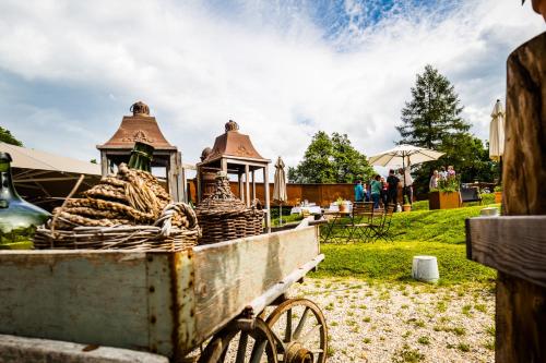 a cart full of hay sitting on the grass at Apart Hotel Wetterhorn in Hasliberg