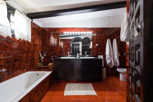 a bathroom with a bath tub and a sink at Villa Coki Deluxe - First line of the beach in Telde