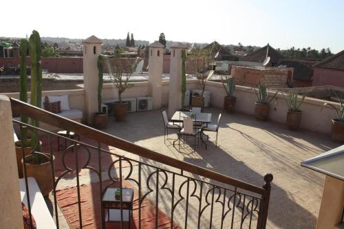 a patio with a table and chairs on a balcony at Riad Shama Suites & Spa in Marrakech