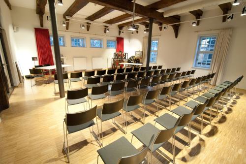 an empty room with chairs and tables in it at Hotel Am Kloster in Wienhausen