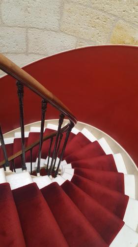 a staircase with a red and white stair case at Hotel Bleu de Mer in Bordeaux