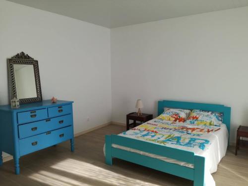 a bedroom with a blue bed and a blue dresser at Pés Verdes-Alojamento e Chá in Ponta Delgada