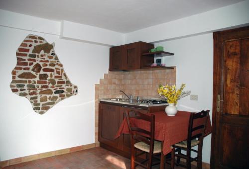 a kitchen with a table and a sink and a counter at Casale il Colle Deruta in Deruta