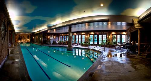 a large swimming pool in a building at night at Mirror Lake Inn Resort and Spa in Lake Placid